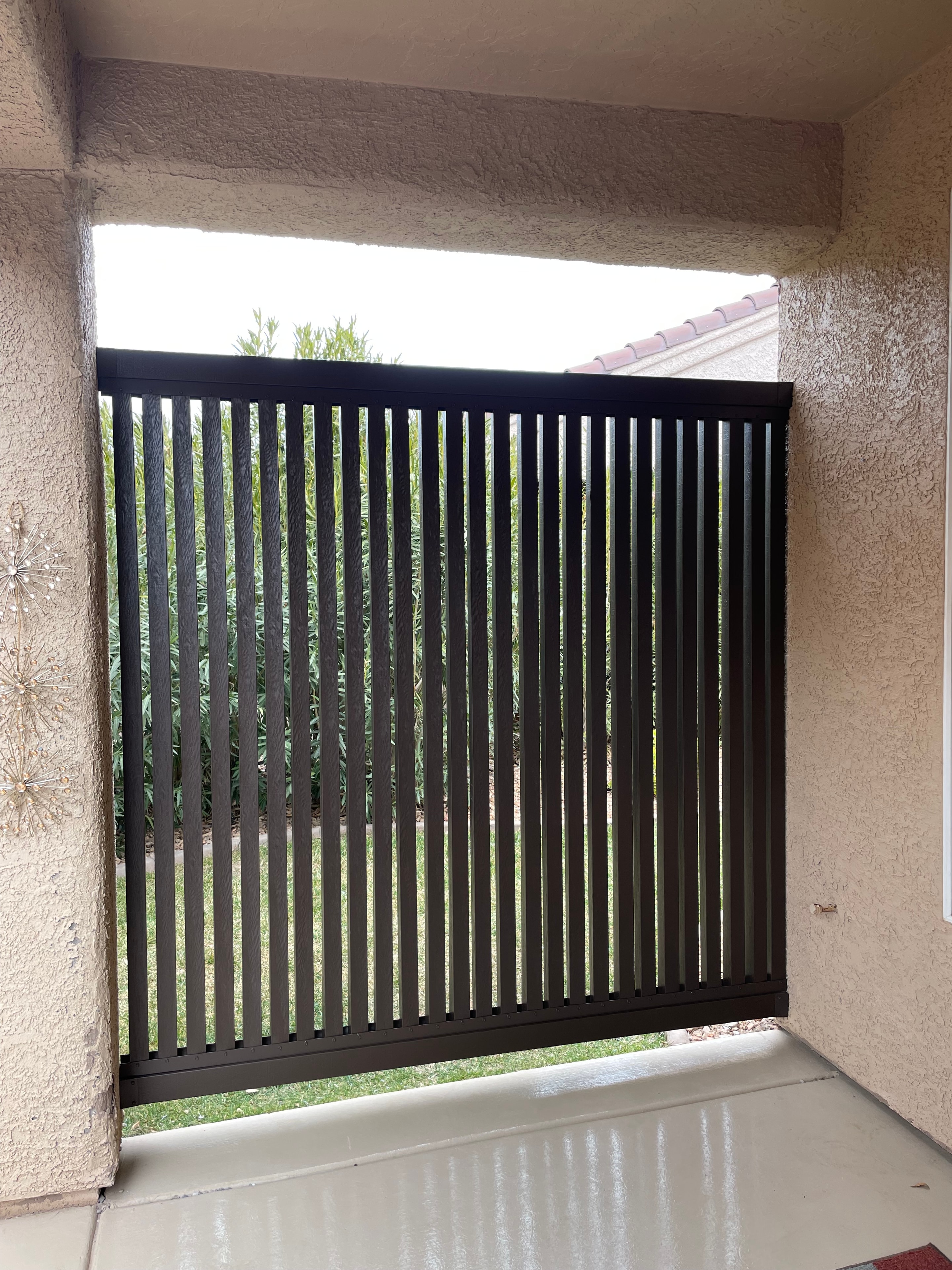 Modern wood slat privacy screen installed in a backyard